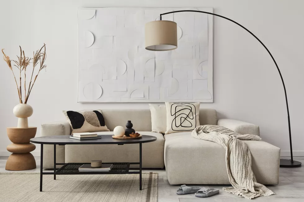 modern-concept-living-room-interior-with-design-sofa-pillow-blanket-art-painitngs-side-wooden-stool-lamp-elegant-personal-accessories-stylish-home-decor