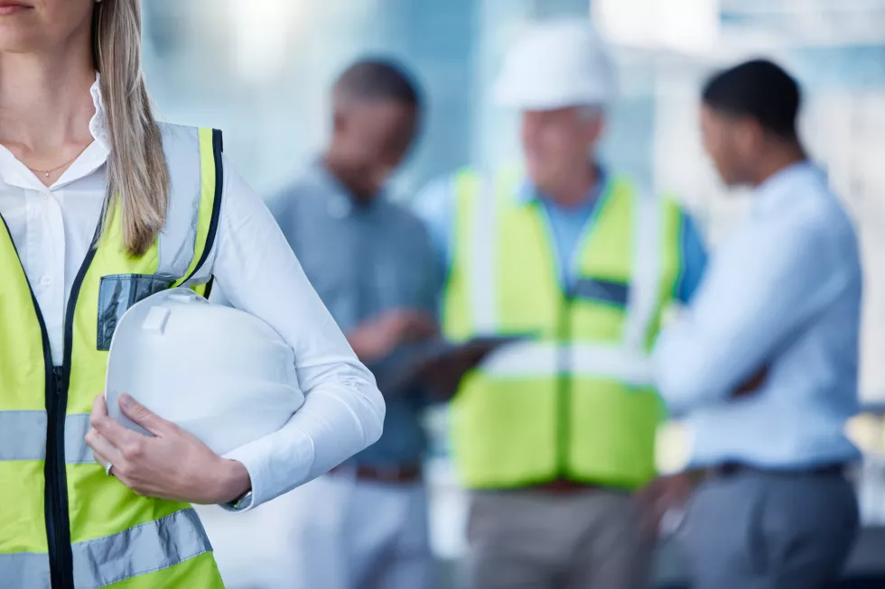 architecture-planning-woman-with-helmet-blurred-office-project-management-teamwork-inspection-civil-engineering-collaboration-contractor-construction-site-with-safety-gear