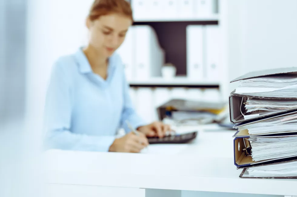 binders-with-papers-are-waiting-be-processed-by-business-woman-bookkeeper-back-blur-internal-audit-tax-concept